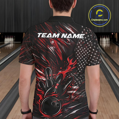 Back view of a male model in a bowling center wearing a black and red polo shirt featuring a flaming bowling ball hitting the pins.