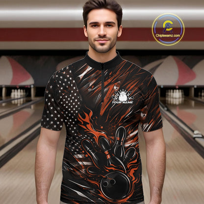 Male model wearing a black and orange bowling quarter-zip shirt at a bowling lane with fiery bowling strike artwork and patriotic styling.