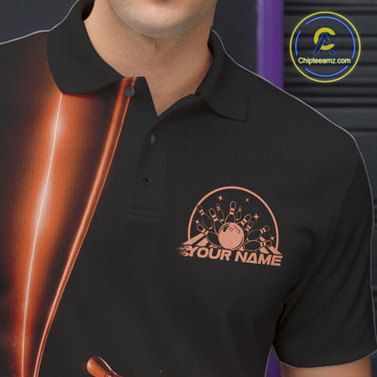 Close up left chest of bowling polo shirt, black fabric featuring orange bowling ball and pins emblem, detailed apparel branding perspective