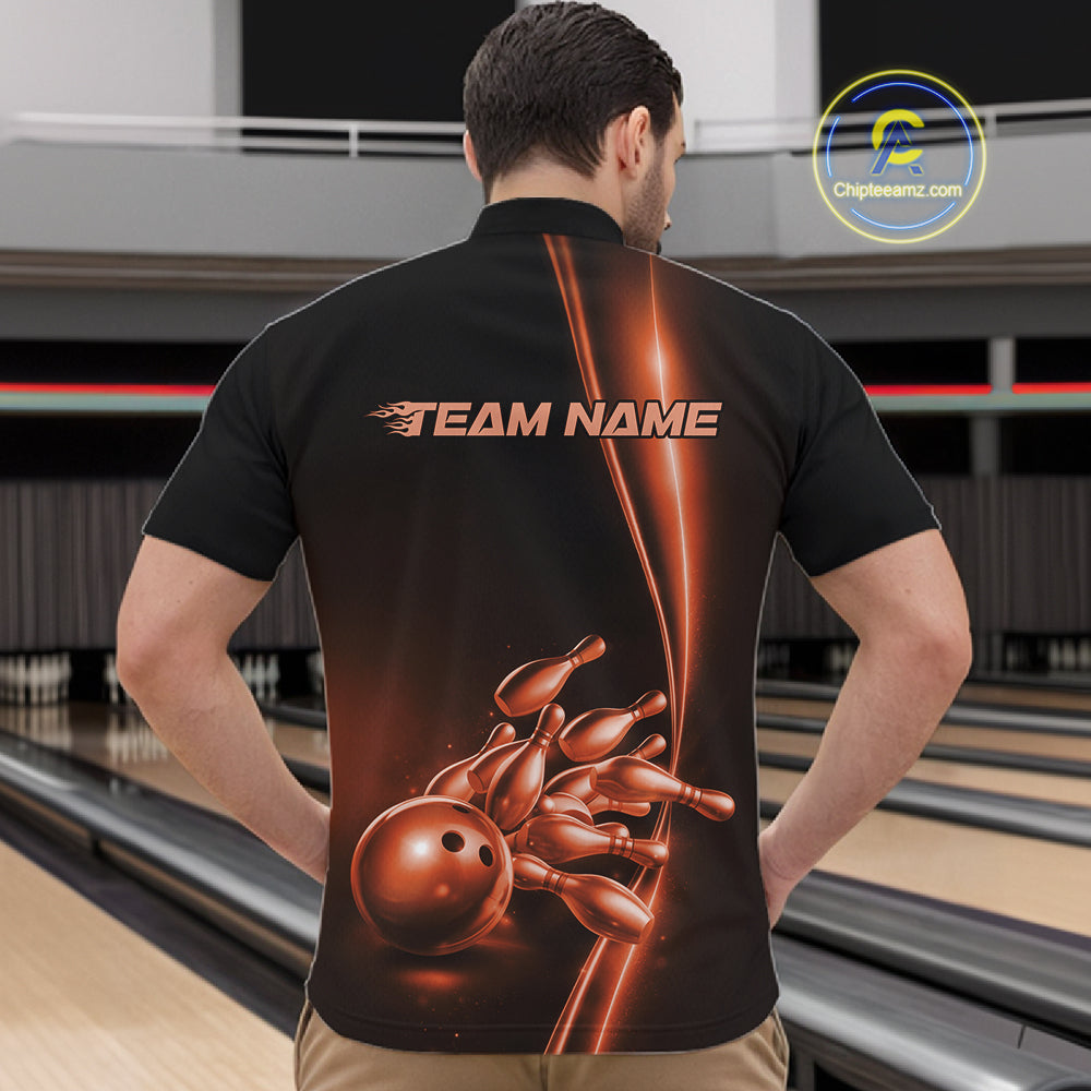 Front view of a male model in a bowling lane wearing a black quarter-zip shirt featuring orange bowling ball and pins design with bold sports styling.