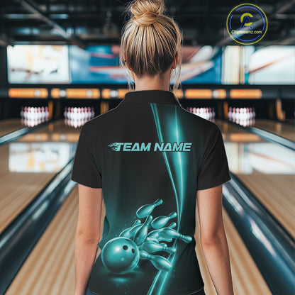 Back view of a female model in a bowling lane wearing a black quarter-zip shirt featuring turquoise blue bowling ball and pins design with sporty bowling graphics.
