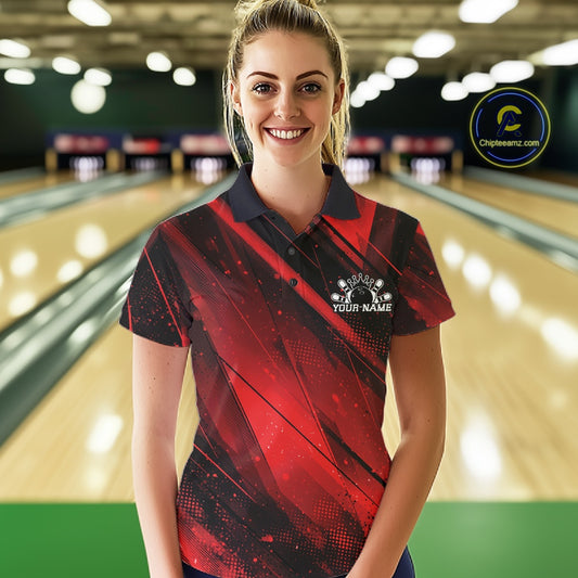 Woman in a red and black bowling shirt with a logo in a bowling alley.
