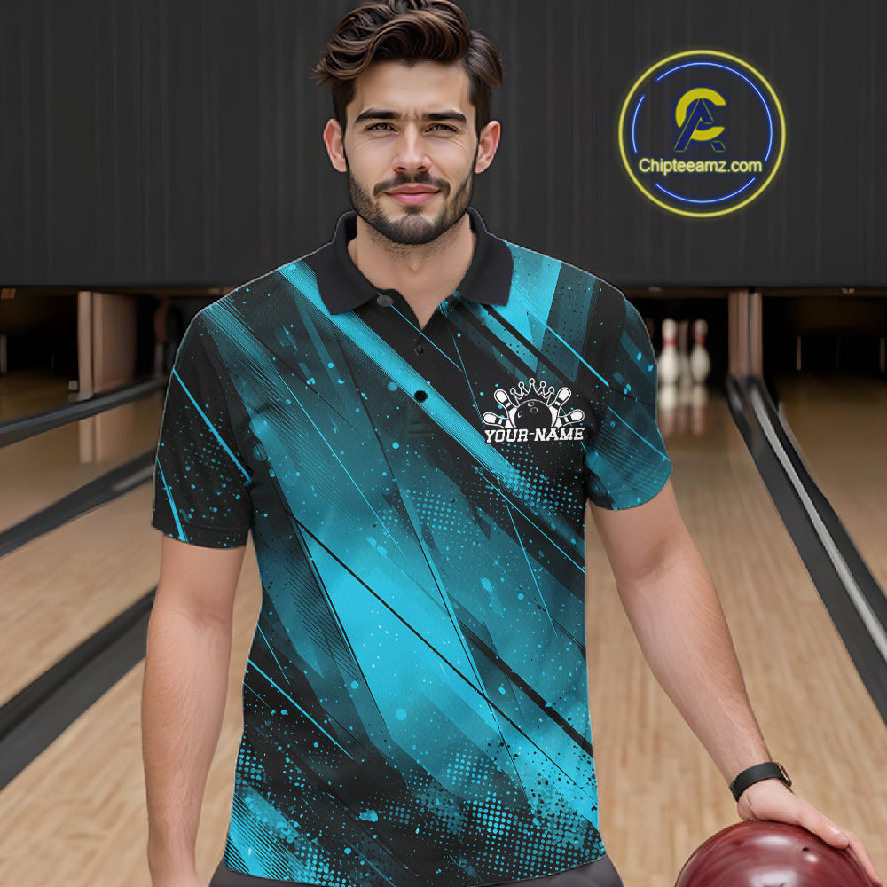 Man wearing a blue and black bowling shirt with a logo in a bowling alley.