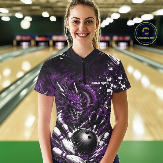 Woman wearing a purple bowling shirt with a dragon design in a bowling alley.
