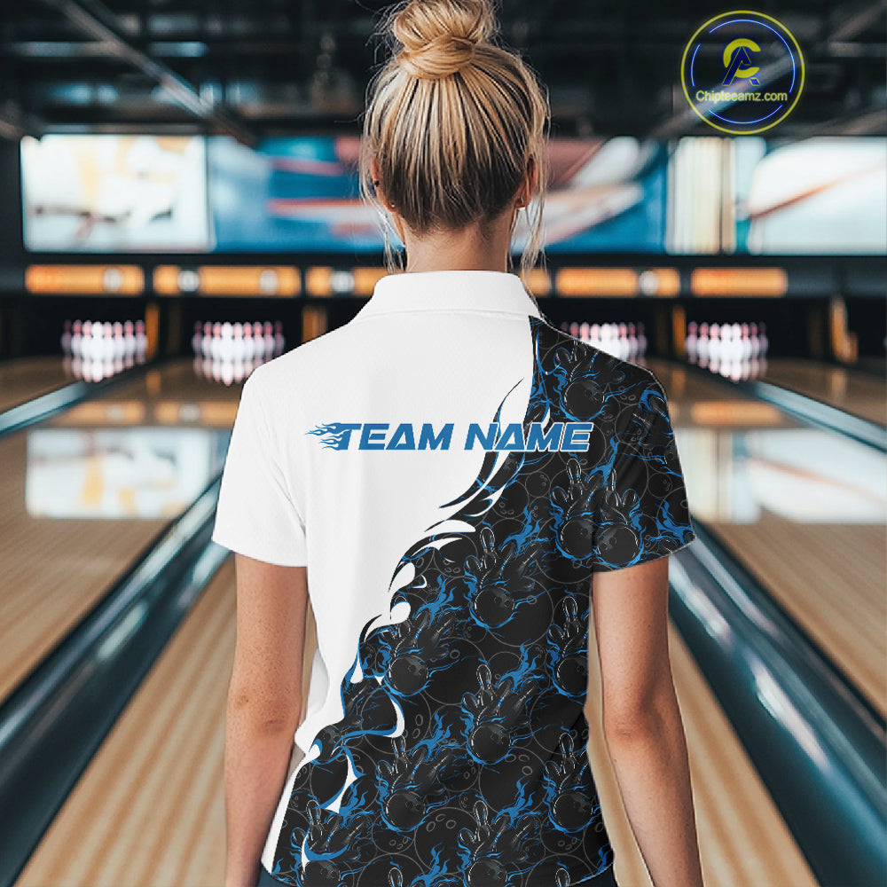 Back view of female model at bowling lane wearing white polo shirt with blue and black flame bowling pattern, inside bowling venue, relaxed stance