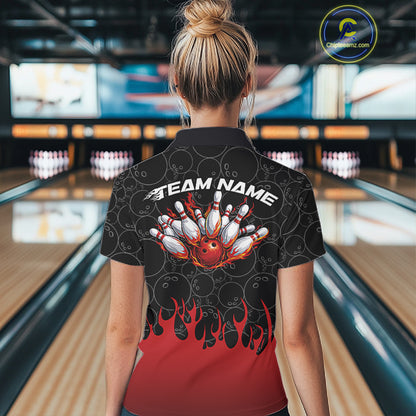 Back view of a female model in a bowling lane wearing a black polo shirt featuring bowling ball pattern with vibrant red flames rising from the bottom and dynamic flaming bowling graphics.