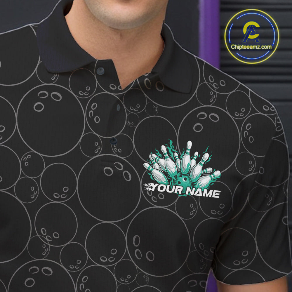 Close-up view of the left chest of a black bowling polo shirt featuring bowling ball pattern with vibrant turquoise green flames rising from the bottom.