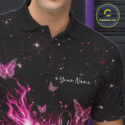 Left chest close-up of a black and pink bowling polo shirt with a flaming bowling ball, glowing butterflies, and cosmic accents.