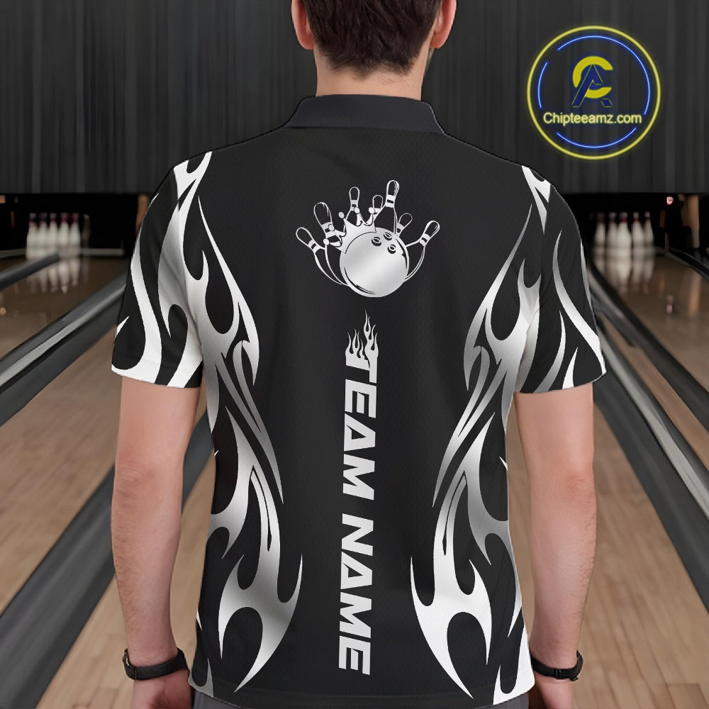 Male model seen from the back in a bowling lane wearing a black polo shirt featuring a silver metal tribal flame bowling ball striking pins in a dynamic motion design.