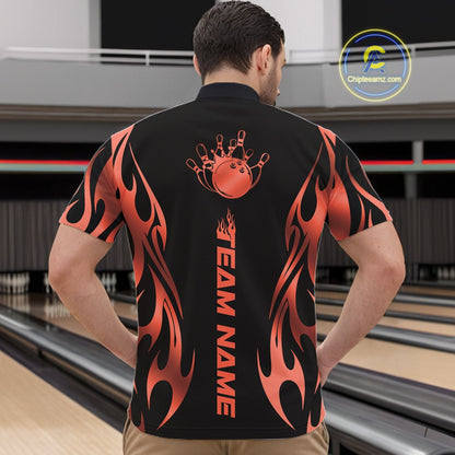 At the bowling venue, front view male model wearing a black quarter zip featuring red gradient tribal flame artwork with a bowling ball hitting pins in motion.