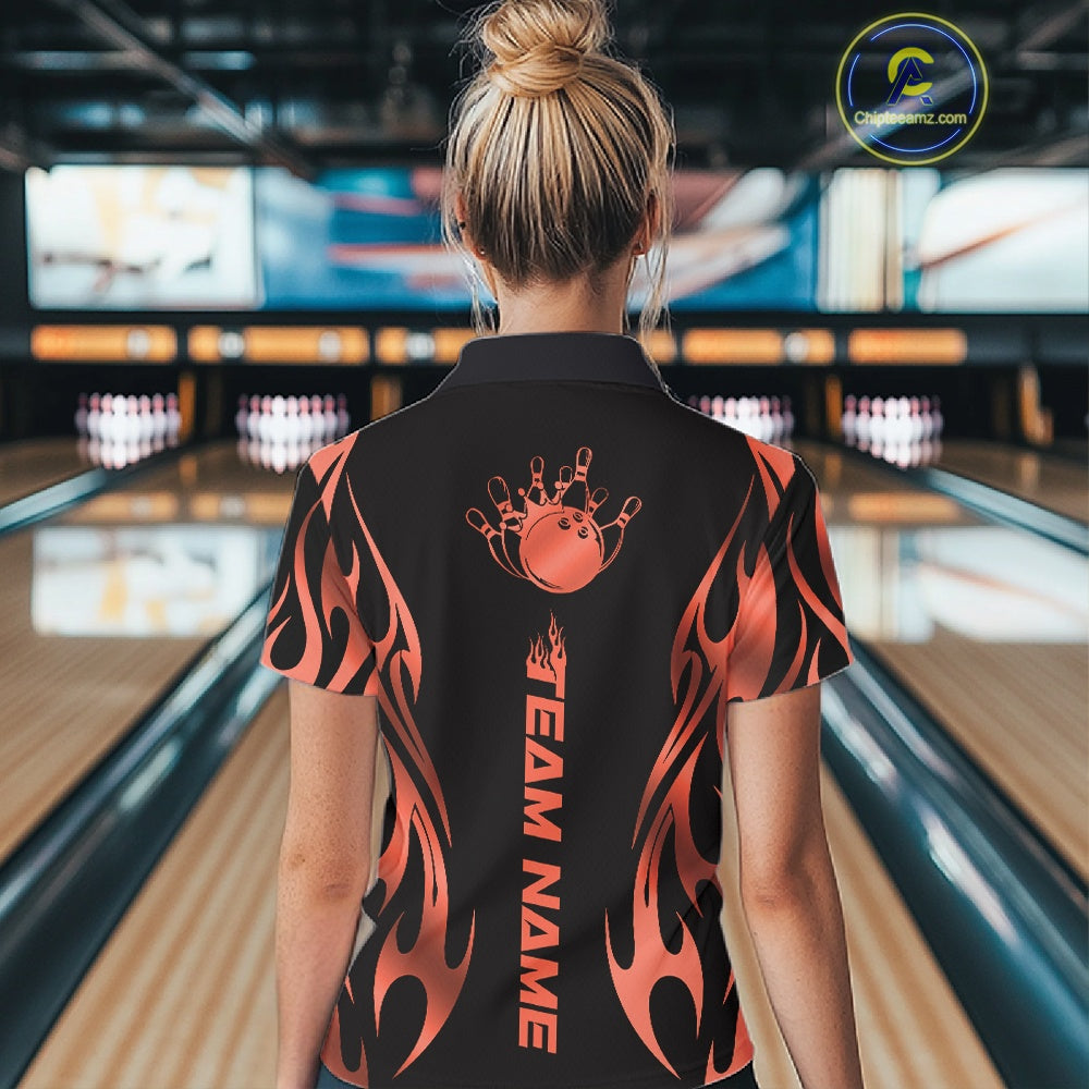 Back view female model at bowling lane wearing black quarter zip shirt featuring red gradient tribal flame bowling ball and pins illustration