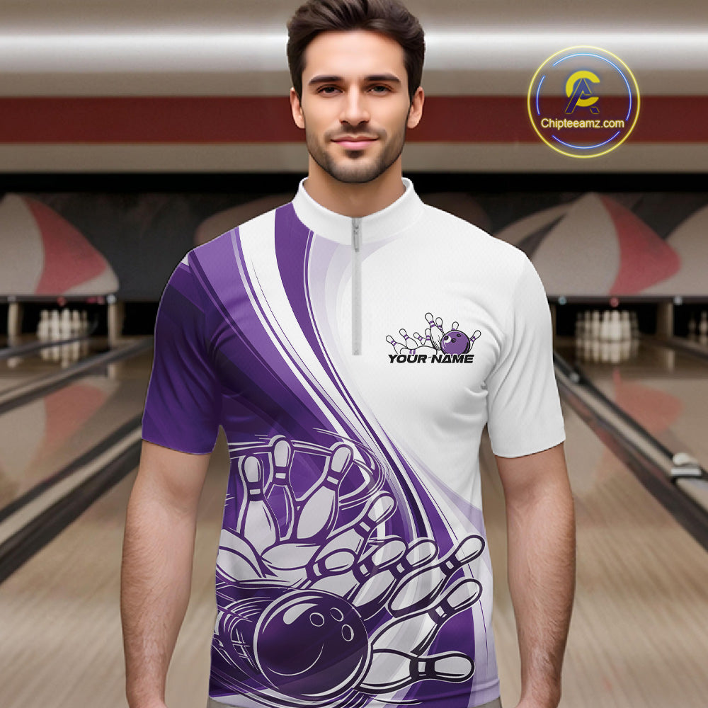 Male model in a bowling lane wearing a white and purple quarter zip shirt with a curved bowling strike graphic and pins being knocked down.