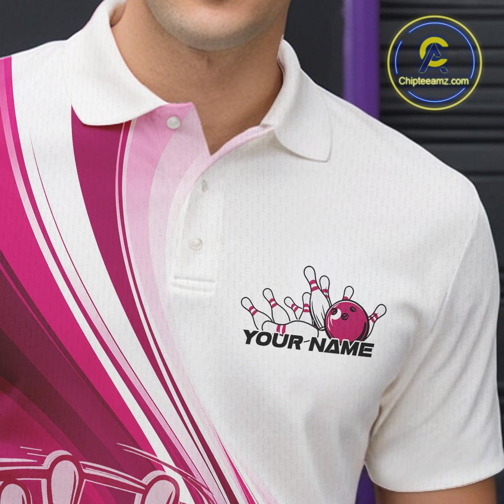 Close-up of the left chest area of a white and pink bowling polo shirt, featuring a dynamic curved bowling ball striking pins design.