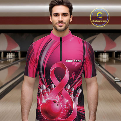 Male model wearing a pink and black bowling quarter zip with breast cancer awareness ribbon graphics and bowling artwork, front view at the bowling lane