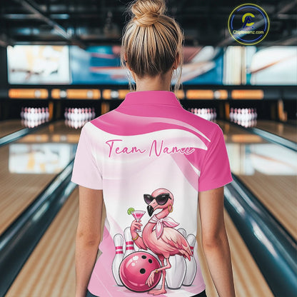 Back view of a female model in a bowling center wearing a pink polo shirt showcasing a stylish flamingo beside a bowling ball.