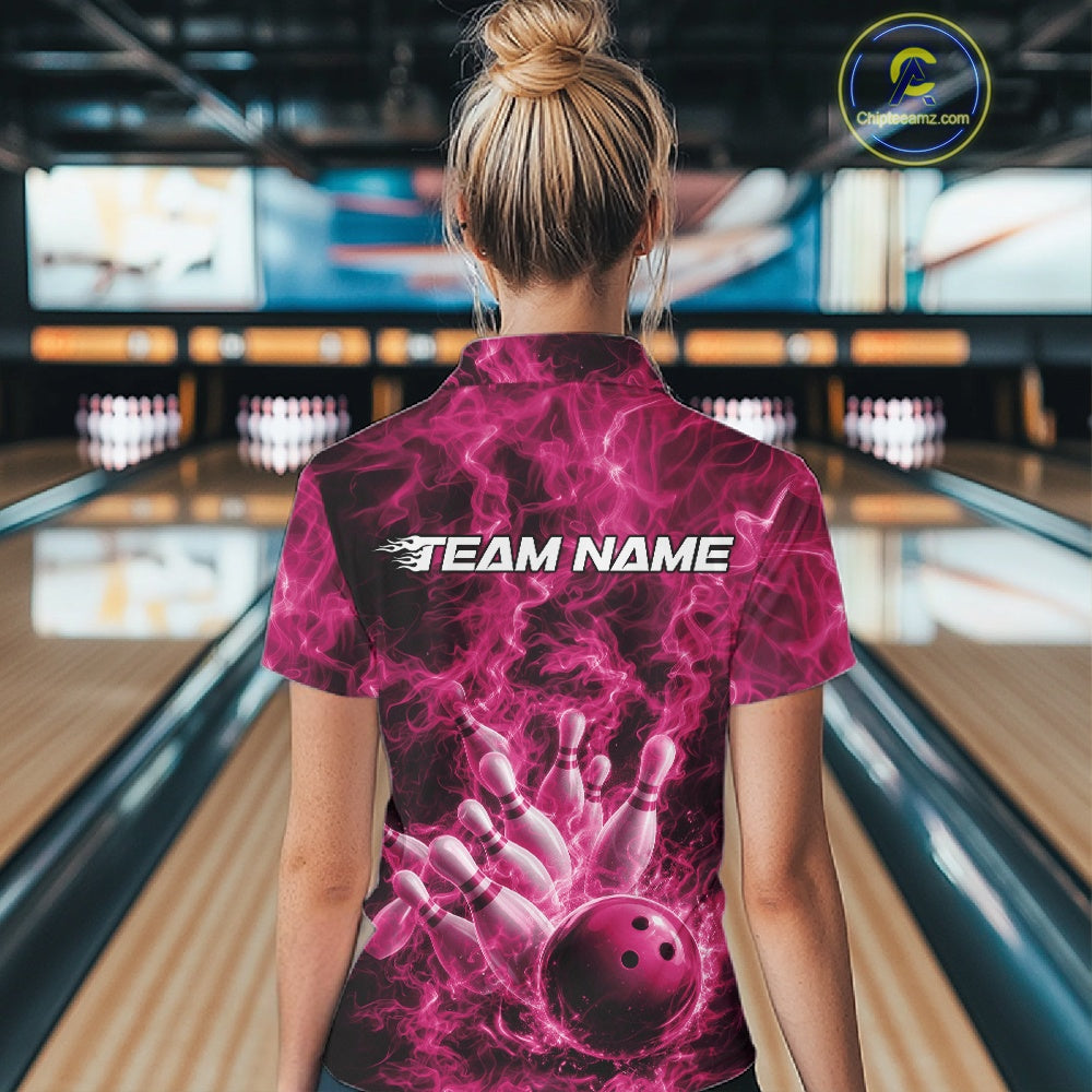 Back view of a womens bowling quarter-zip showcasing a pink bowling ball striking pins against a fiery background.