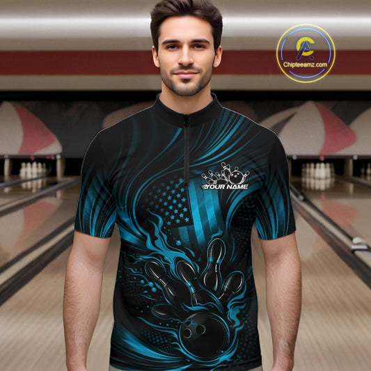Male model wearing a black and turquoise blue bowling quarter-zip shirt at a bowling lane with patriotic bowling strike artwork and flame-inspired accents.