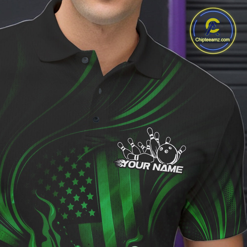 Close-up of a black and green bowling polo shirt left chest showing patriotic flames around a bowling ball striking pins with distressed flag design.