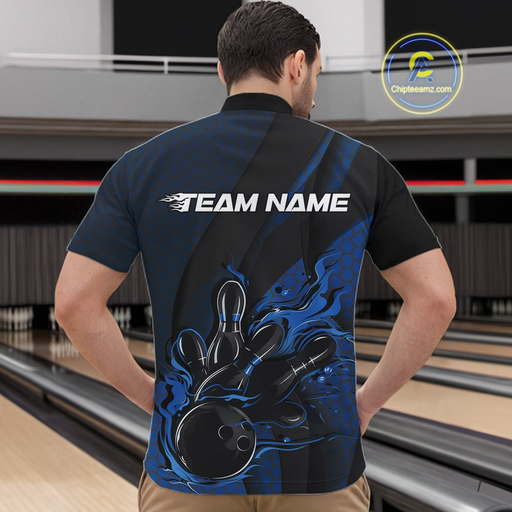 Front view of a male model in a bowling alley wearing a black and blue quarter-zip shirt featuring a flaming bowling ball knocking down pins.