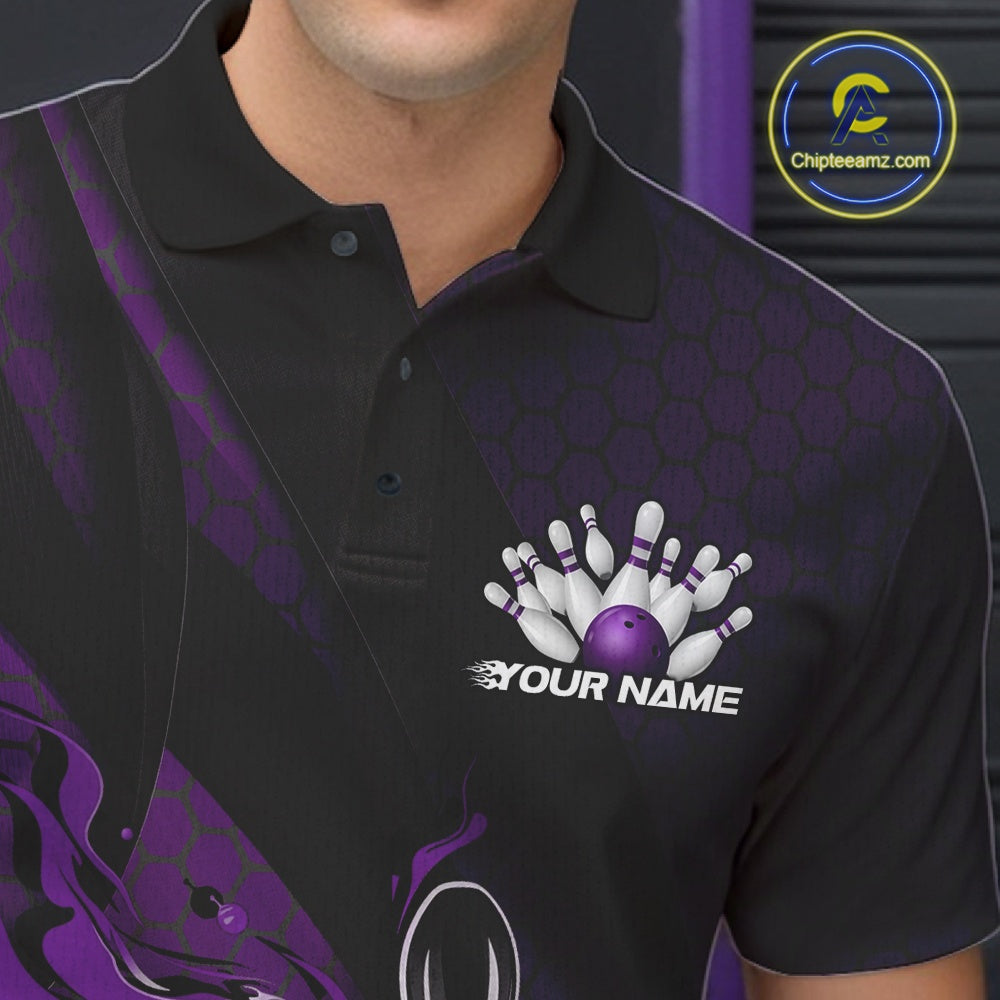 Close-up of the left chest area on a black and purple bowling polo shirt featuring a flaming bowling ball and pin design with diagonal stripes.