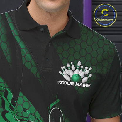 Close-up of the left chest on a black and green bowling polo shirt featuring a flaming bowling ball and pin motif with geometric details.