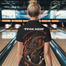 Load image into Gallery viewer, Back view of a female model in a bowling alley wearing an orange custom quarter-zip bowling shirt featuring an aggressive dragon with flames in a dynamic and energetic design.