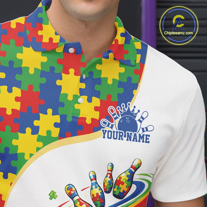 Close-up left chest detail of white bowling polo shirt showcasing colorful autism bowling strike emblem with puzzle-inspired graphics