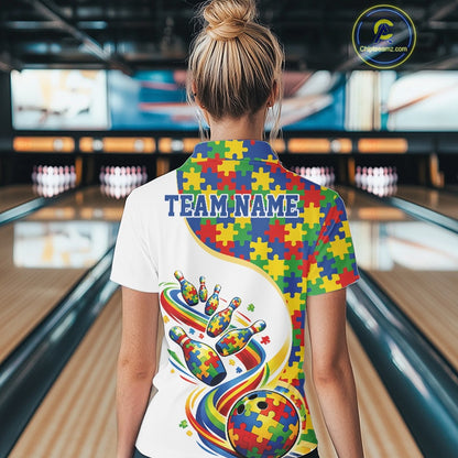 Back view of a female bowler wearing a white quarter-zip shirt, autism puzzle bowling design with vibrant multicolor sports graphics.