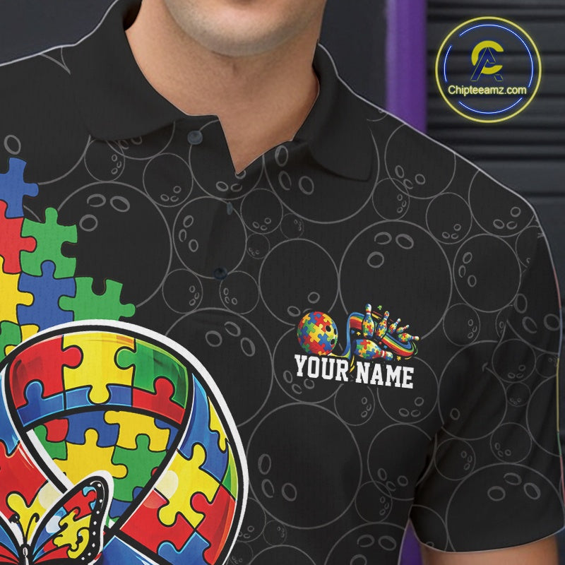 Close-up left chest detail of black bowling polo shirt featuring autism ribbon puzzle emblem with butterfly and bowling strike accents