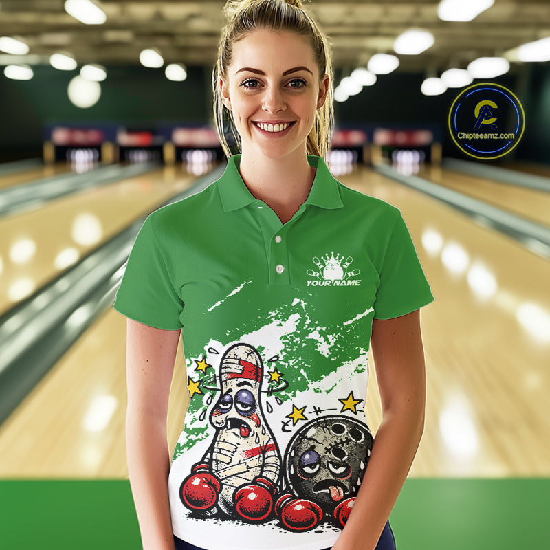 Female model in a bowling lane wearing a green and white polo shirt, cartoon boxing bowling ball and pin artwork with playful tone.