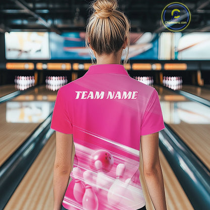 Female model back view in a bowling lane wearing a pink quarter zip shirt with bowling ball and pins over a pink geometric pattern.