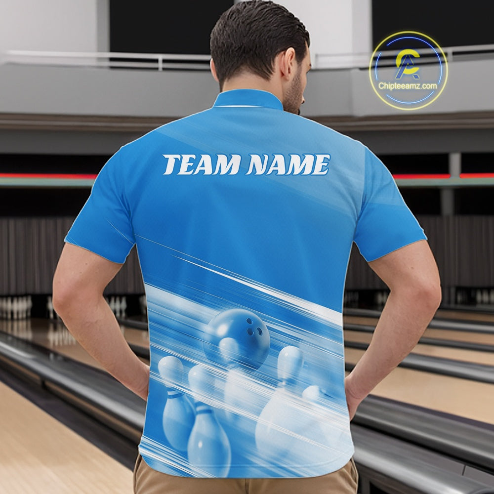 Male model front view in a bowling lane wearing a blue bowling quarter zip shirt with bowling ball and pins geometric graphics.