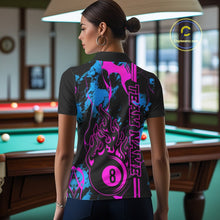Load image into Gallery viewer, Back view female model wearing a polo shirt with flaming billiard 8 ball motif on a blue and green abstract background.