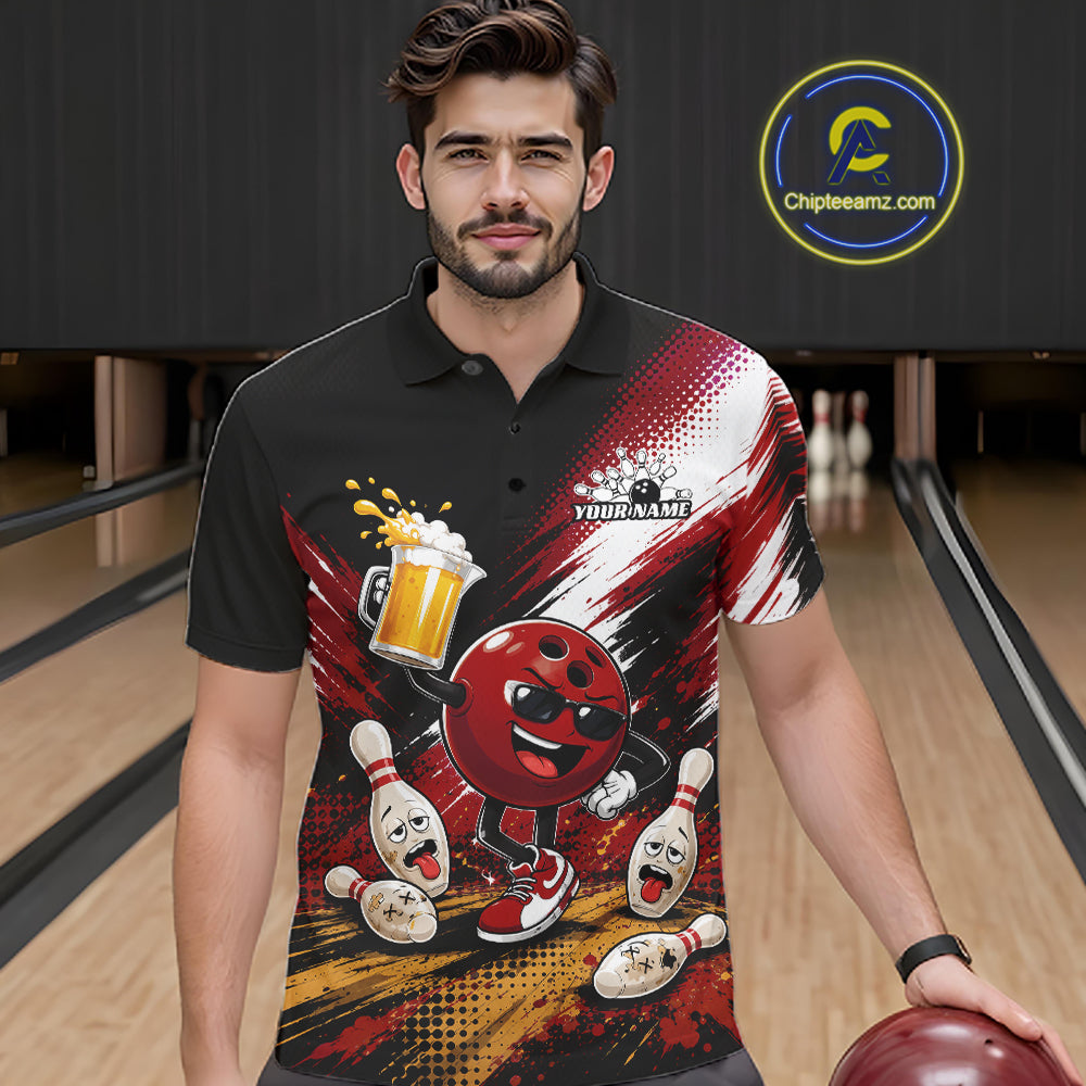 A man wearing a black short-sleeve polo shirt with a bold bowling-themed graphic print featuring a red bowling ball character, pins, beer, and a customizable name patch. The background shows a blurred bowling alley with lanes and pins.