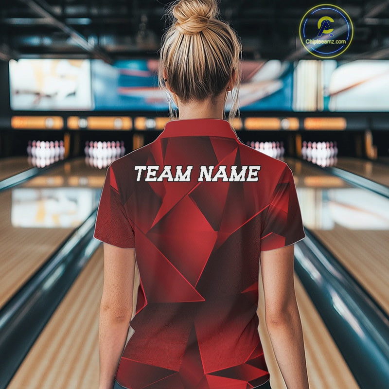 Person wearing a red shirt with 'TEAM NAME' on the back in a bowling alley.