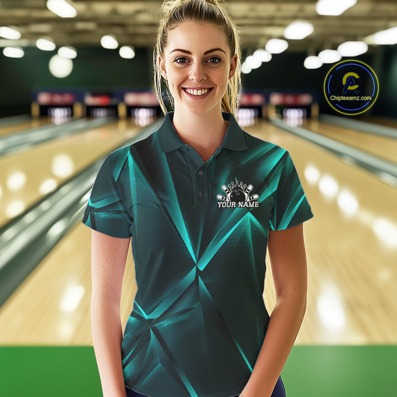 Woman wearing a teal bowling shirt with a logo in a bowling alley