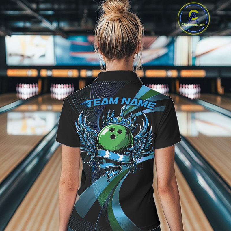 Person wearing a black bowling shirt with a green bowling ball design in a bowling alley.