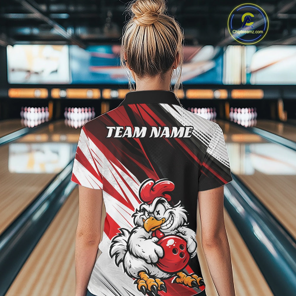 A woman viewed from behind wearing a custom bowling shirt in a bowling alley. The shirt features a black, red, and white graphic design with a cartoon chicken mascot holding a red bowling ball and the text 'TEAM NAME' printed across the upper back.