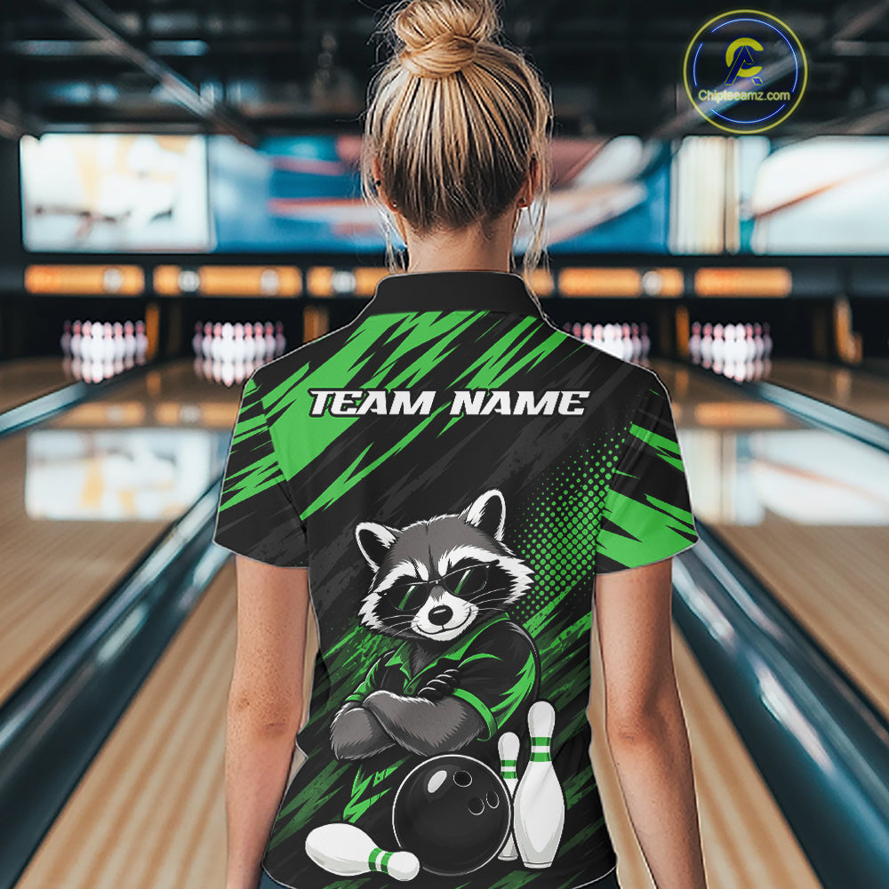 A woman viewed from behind wearing a short-sleeve bowling polo shirt with a raccoon graphic and the text 'TEAM NAME' on the back, standing in a bowling alley.