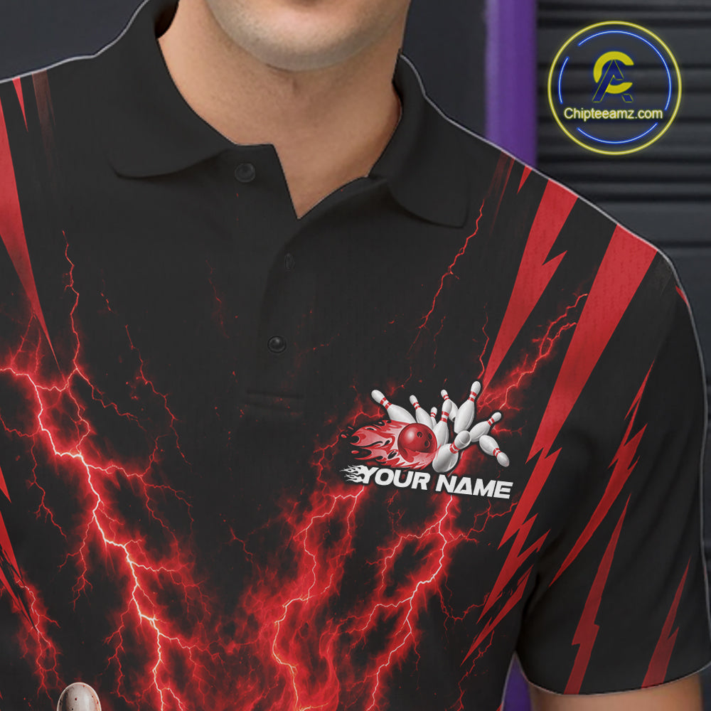 A close-up of a black short-sleeve polo shirt with a red and black lightning-bolt graphic pattern, featuring a bowling pin and ball logo with the text 'YOUR NAME' on the left chest. 
