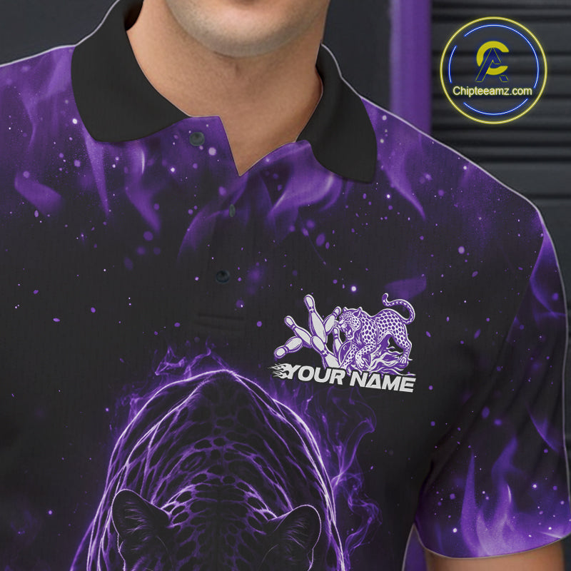 Close-up view of the left chest of a black polo shirt showing glowing purple electric panther artwork with bowling ball crashing through pins detail.