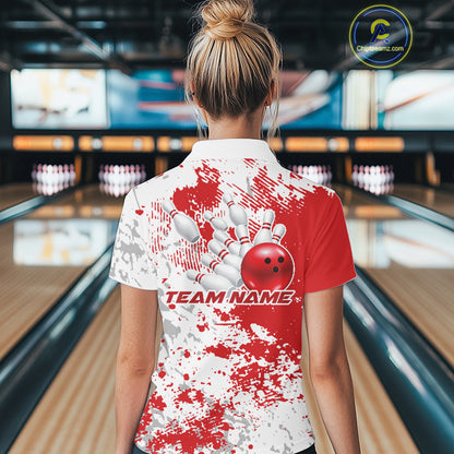 Back view female model at bowling lane wearing white polo with red and white splatter background, relaxed pose in bowling venue