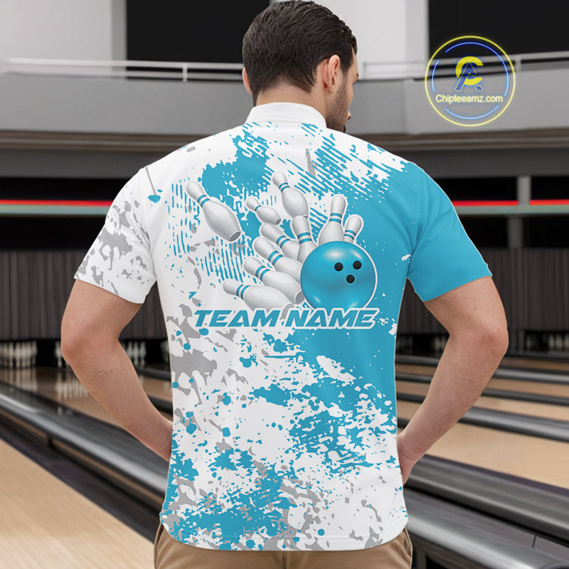 Male model at a bowling lane wearing teal blue and white quarter zip shirt, front view featuring blue-toned splatter background with abstract design