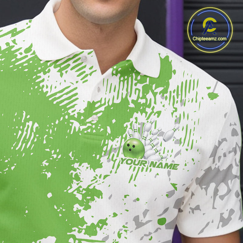 Close-up view of the left chest of a green and white splatter polo shirt showing clean abstract bowling-inspired design detail.