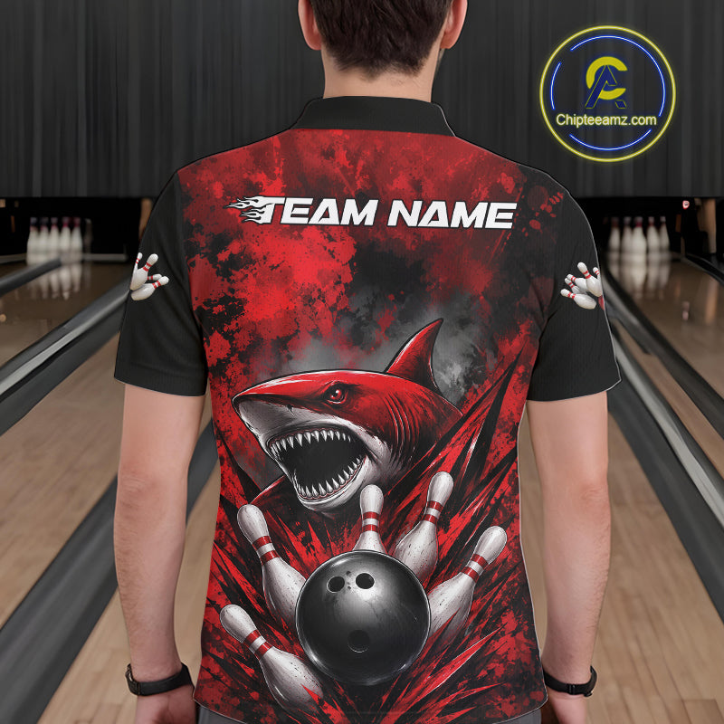 Person wearing a red and black bowling shirt with a shark design in a bowling alley.