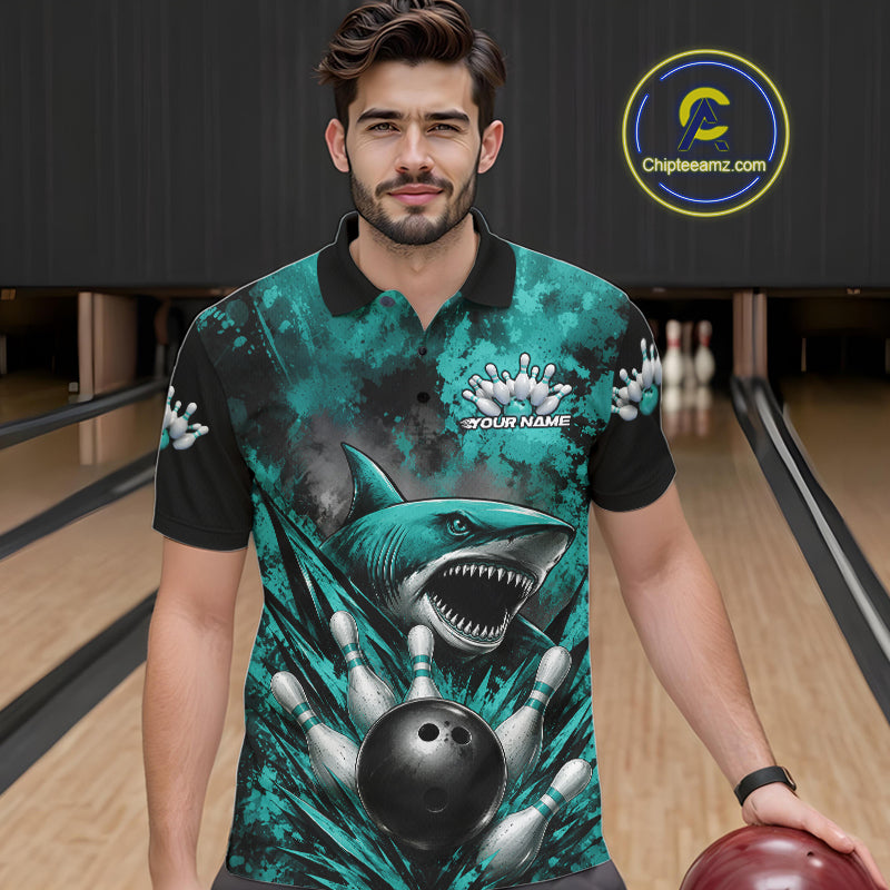 Man wearing a teal bowling shirt with shark design in a bowling alley.