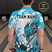 Load image into Gallery viewer, Person wearing a blue bowling shirt with a dragon design and 'TEAM NAME' text at a bowling alley.