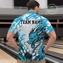 Load image into Gallery viewer, Man wearing a blue bowling shirt with a dragon design and 'TEAM NAME' text in a bowling alley.