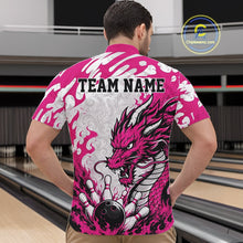 Load image into Gallery viewer, Person wearing a pink and white bowling shirt with a dragon design and 'TEAM NAME' text, standing in a bowling alley.