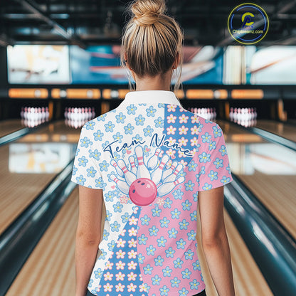 Back view female model in bowling alley wearing white polo shirt with white, blue and pink floral pattern, standing near lane
